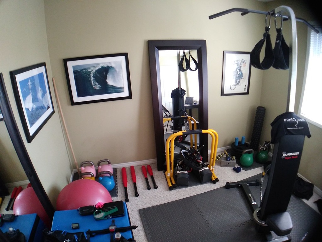 Kompakt hemmagym med träningsutrustning som bollar, kettlebells och resistansband.